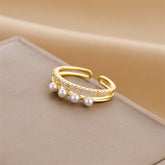 Close-up of geometric gold ring featuring zircon and jade detailing